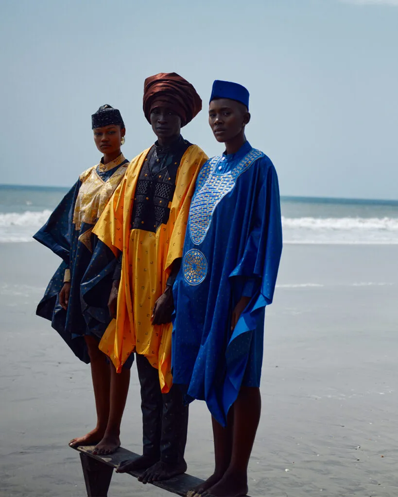 Three models wearing garments on a beach, from Recycle, Rework, Reuse